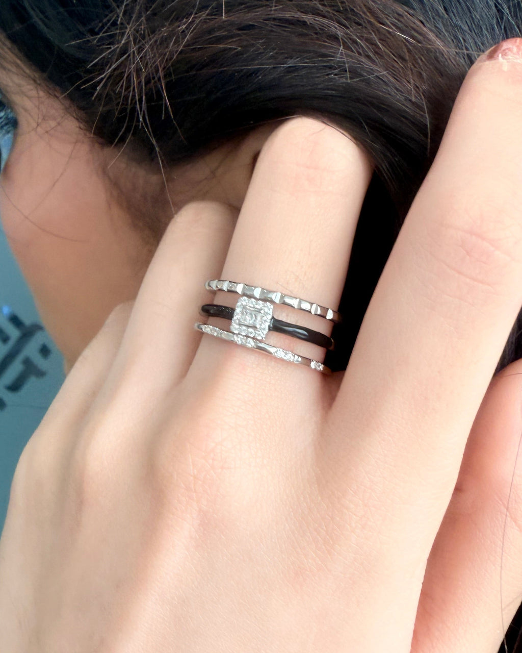 Hand with a ring on a blurred background
