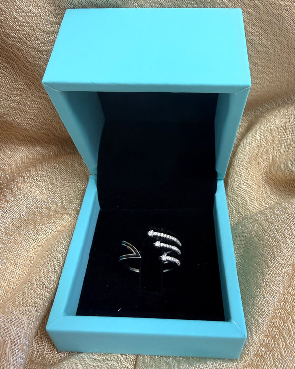 Light blue jewelry box with a black interior on a textured beige surface